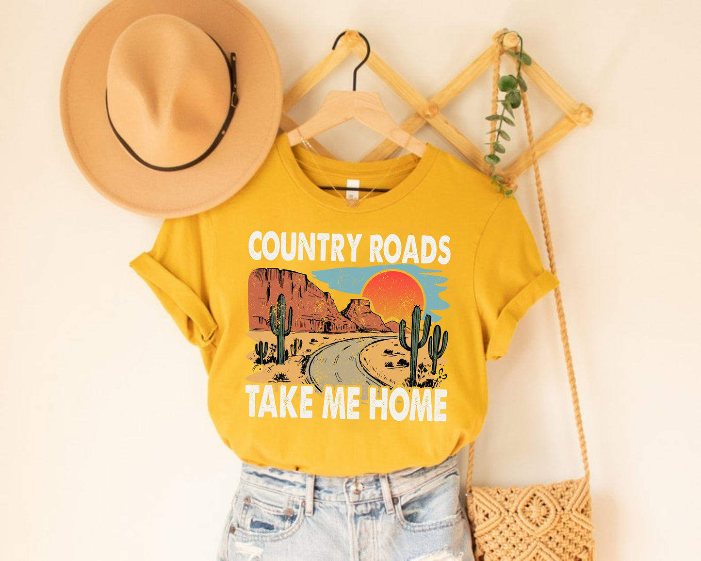 yellow tshirt with country roads graphic printed on the front