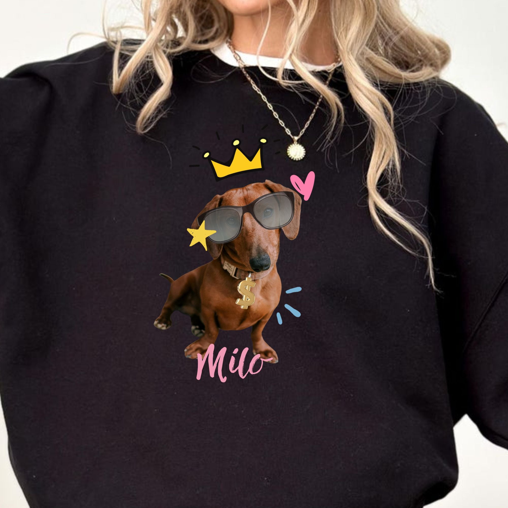 Black sweatshirt with a dachshund graphic and 'Milo' text, worn by a person.