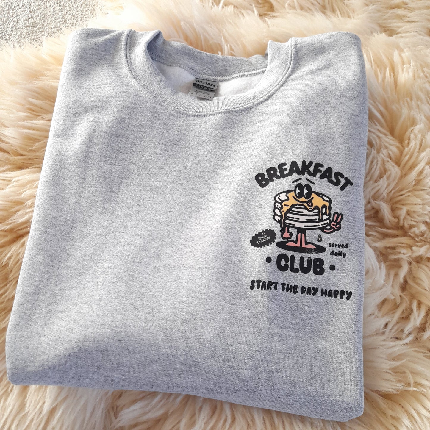 Grey crewneck jumper with retro style print of popular breakfast club pancakes 